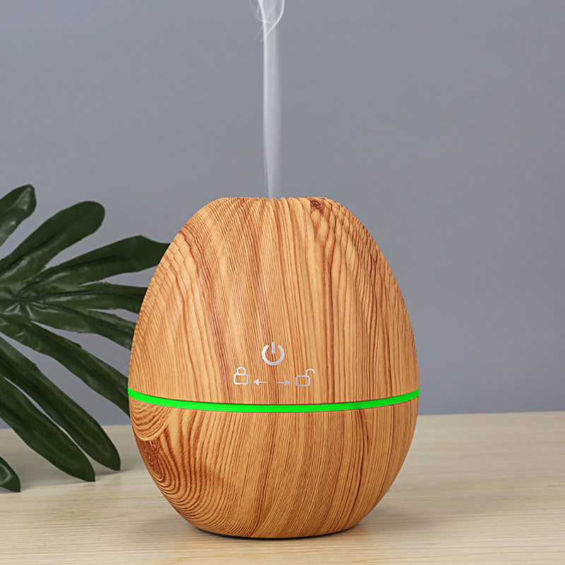a light wood color usb portable humidifier is running with mist upward