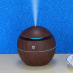 a dark wood color mini portable humidifier is running