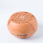 an electric fragrance diffuser in light wood color