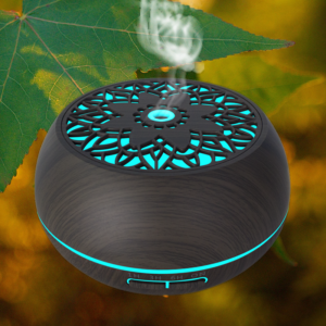 an electric aroma oil diffuser in dark wood color