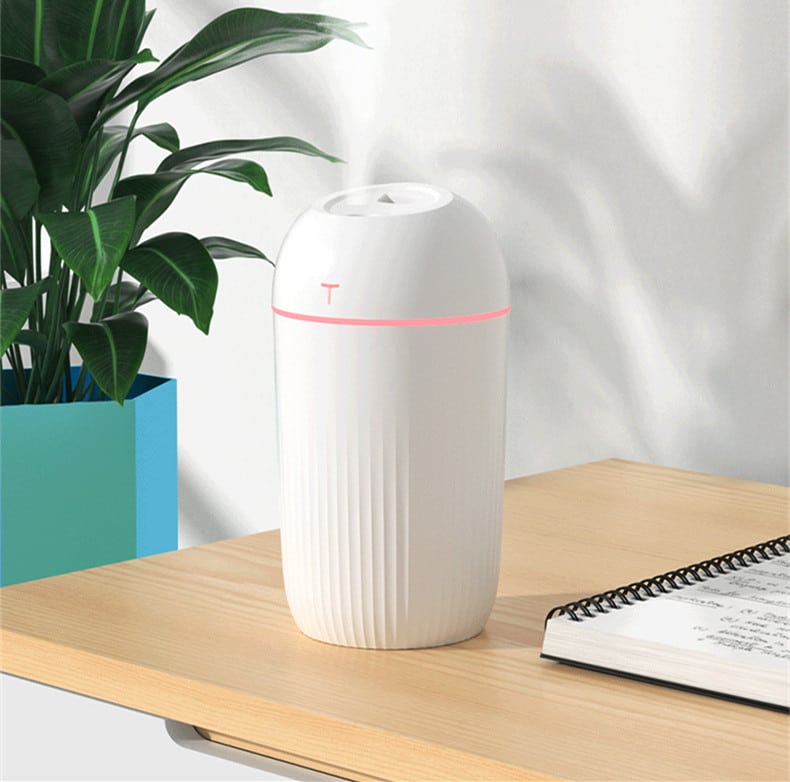 a white color usb colorful humidifier on the desktop