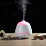 a white color mini usb diffuser is running with mist upward