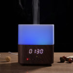 a aroma diffuser with bluetooth speaker shows the time