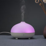 a white color usb aromatherapy diffuser is running with mist