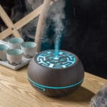 a wood aromatherapy diffuser is running with mist upward