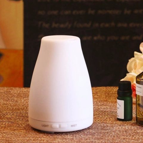 a white color portable aroma diffuser on the desktop