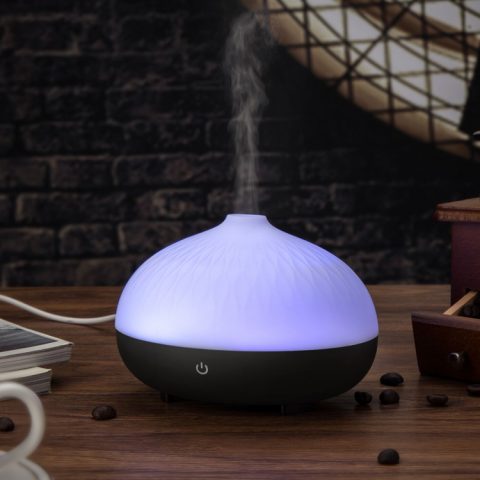a wood base usb aromatherapy diffuser is running with mist