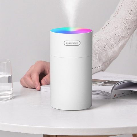 a white color mini air cooler humidifier on the desktop
