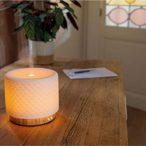 a bamboo base ceramic aroma diffuser on the desktop