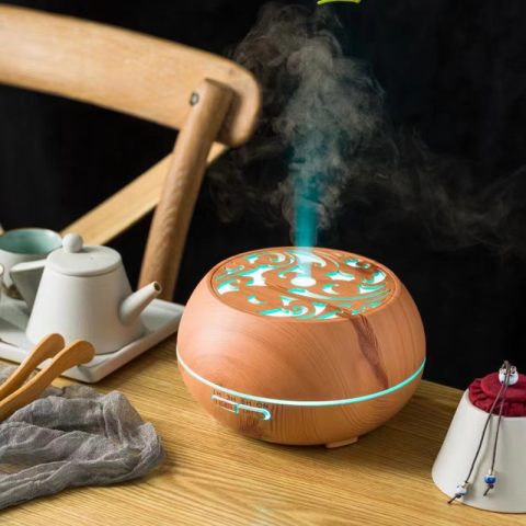 an aroma wood diffuser is running with mist upward